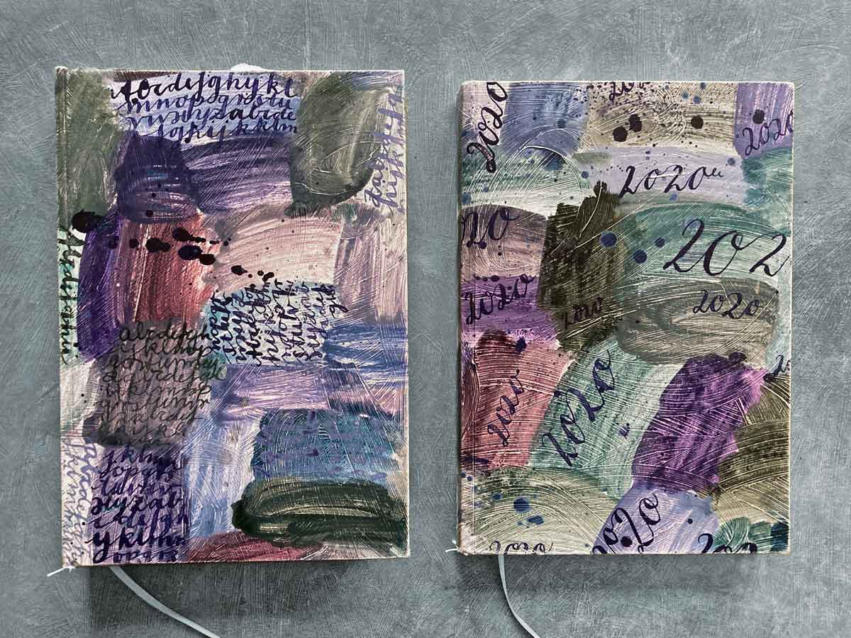 Zwei Skizzenbücher von Tabea Heinicker. Bunt gemustert und mit Handschrift beschrieben.