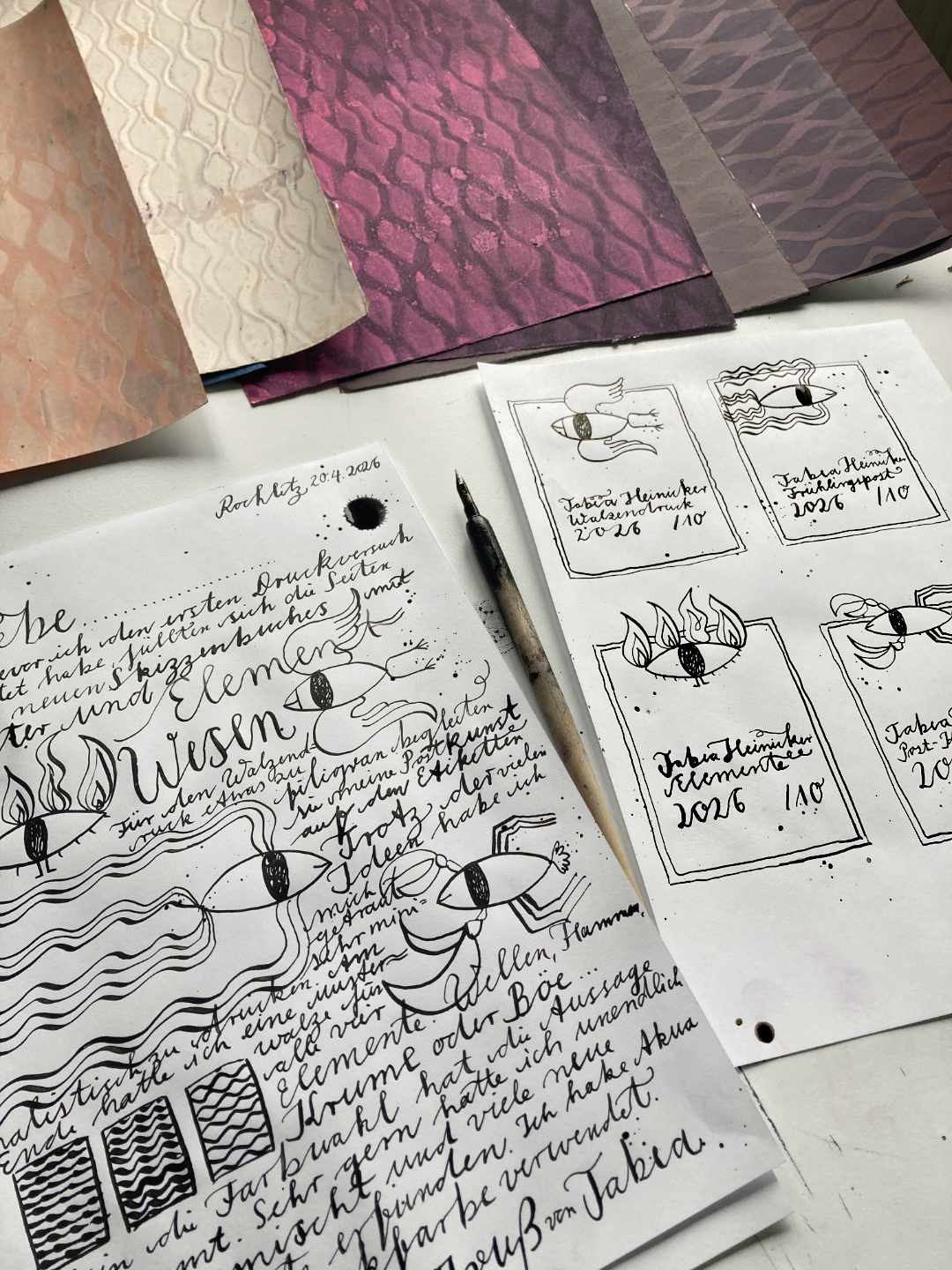 Oben blicken die Walzendrucke ins Bild. Unten entsteht der Bildbrief mit Zeichnungen der Elemente und Handschrift. Rechts daneben vier Etiketten in Schwarz-Weiß für jedes Elemen eins zum Beschriften für die Rückseiten der Drucke